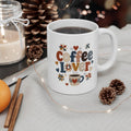 White handled mug with patterned Coffee Lover lettering, hearts, quilt-style stars, and a coffee cup illustration.